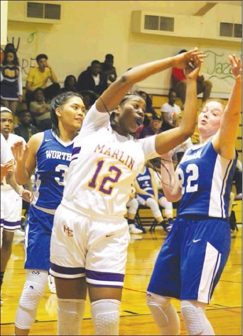 Marlin’s Danielle Noble (12) fights for a rebound against Wortham in a game last week. The 5-foot-11 junior averages 8 points and 10 rebounds per game.            Photo by Skip Leon