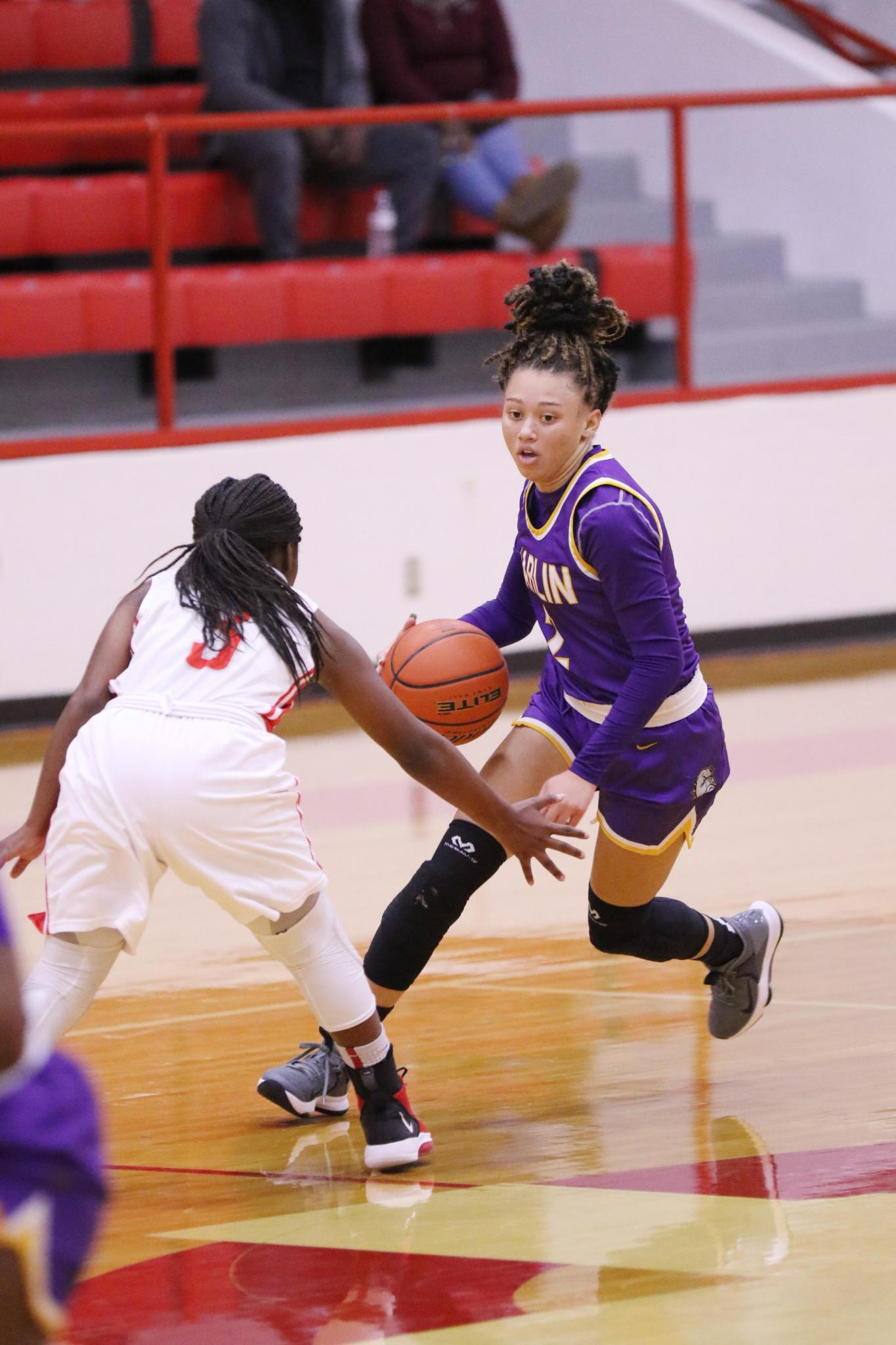 Marlin's McKenna Johnson dribbles against Groesbeck's Kyla Evans (5) during a game at Groesbeck on Friday night.Photo by Angela Crane/For the Marlin Democrat