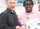 Brent Murphy receives a certificate of excellence for qualifying for the 2026 state powerlifting meet. He was also named Mr. Powerlifting.