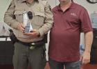  Deputy Eric Correa accepted an award from Reisel Mayor Kevin Hogg.