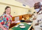 Dr. Marilyn Martin wins PC laptop, Rotarian Treasurer Leonard McGowan.