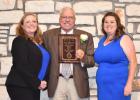 Oldham County Judge Donnie Allred receives his award from Phoenix Rogers, right, TCAAA president, and Amanda Spiva, left, AgriLife Extension agent, Oldham County. (Photo by Kay Ledbetter)